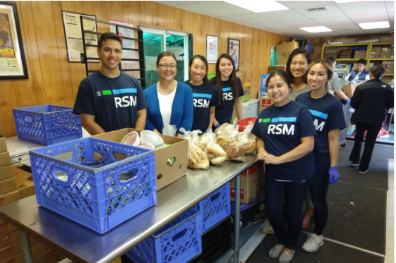 Group of volunteers posting at ACRS Food Bank from Company called RSM